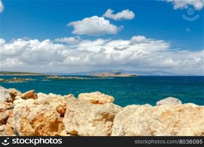 Sea views, waves and stones on a sunny day. Crete. Greece.