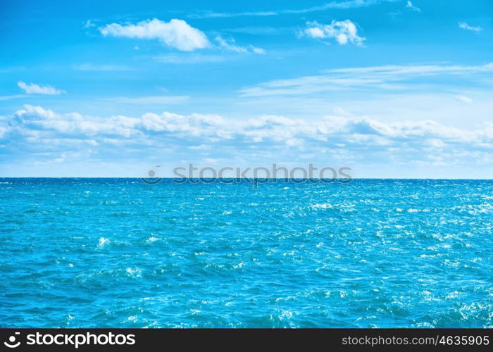 Sea water and blue sky with white clouds. Ocean surface for natural background