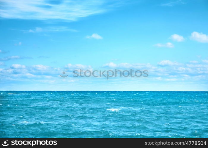 Sea water and blue sky with white clouds. Ocean surface for natural background