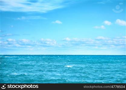 Sea water and blue sky with white clouds. Ocean surface for natural background