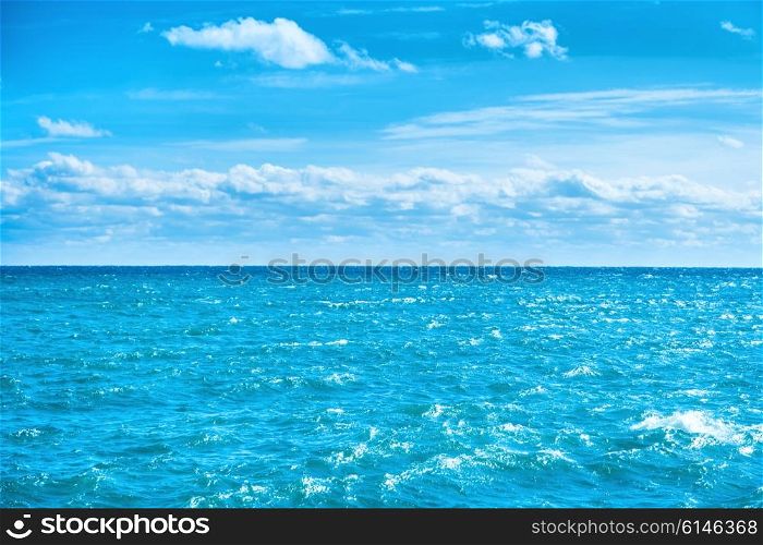 Sea water and blue sky with white clouds. Ocean surface for natural background