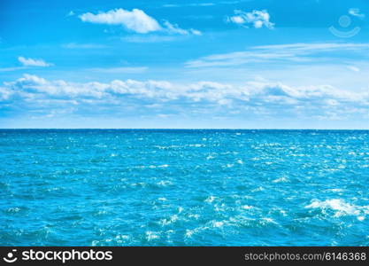 Sea water and blue sky with white clouds. Ocean surface for natural background