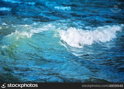 Sea wave on dark blue water in storm