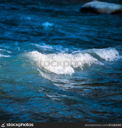 Sea wave on dark blue water in storm