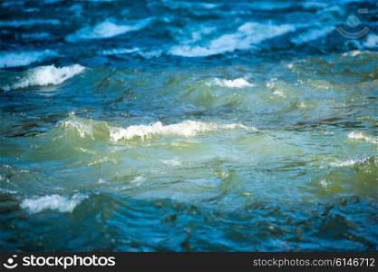 Sea wave on dark blue water in storm