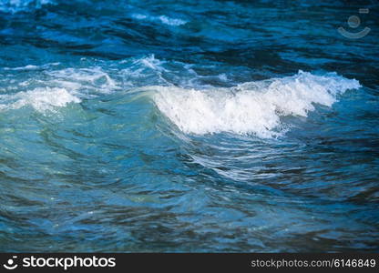 Sea wave on dark blue water in storm