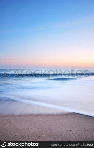 sea wave on the beach at sunset time