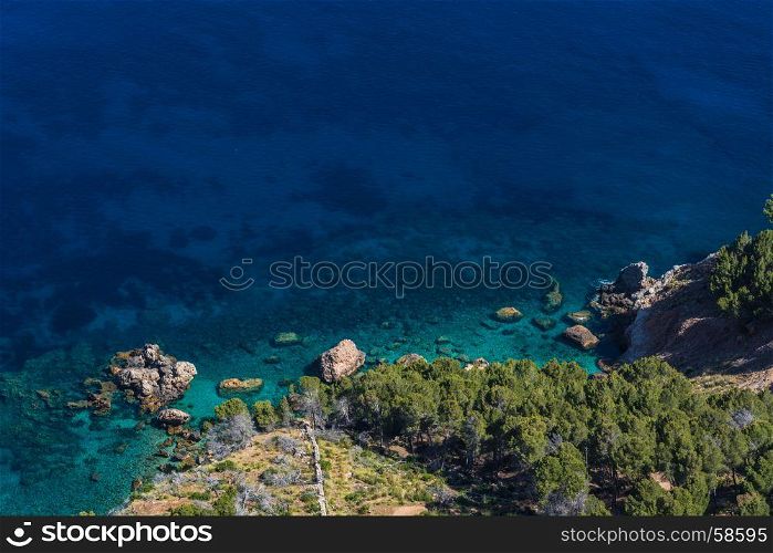 Sea waves and rocks on the steep west coast of Mallorca.