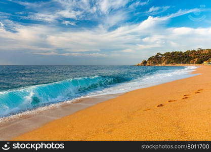 Sea waves and sand main beach at popular holiday resort Lloret de Mar on Costa Brava in the morning , Catalunya, Spain