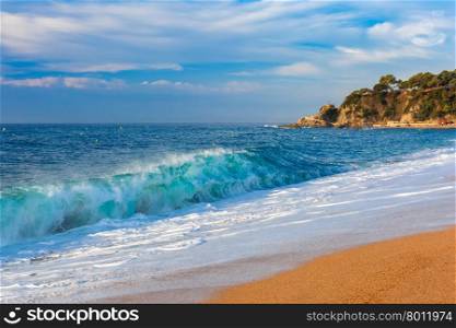 Sea waves and sand main beach at popular holiday resort Lloret de Mar on Costa Brava in the morning , Catalunya, Spain