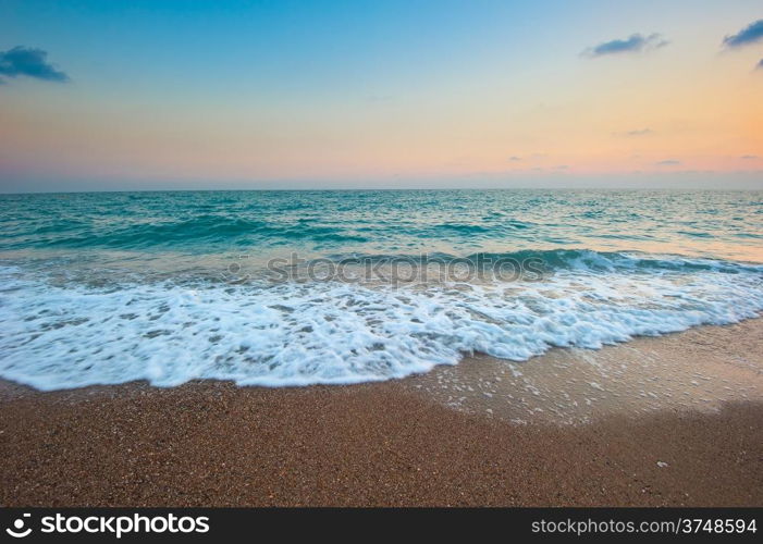 sea ??waves and sandy beach at dawn