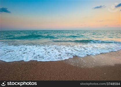 sea ??waves and sandy beach at dawn