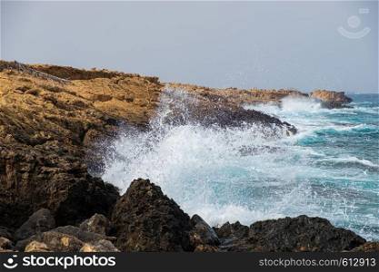 Sea waves crash onto rocks at Apostolos Andreas beach in Karpasia, island of Cyprus