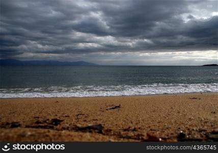 sea waves meeting sandy Greek shores