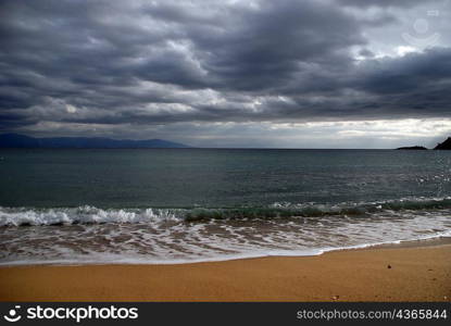 sea waves meeting sandy Greek shores