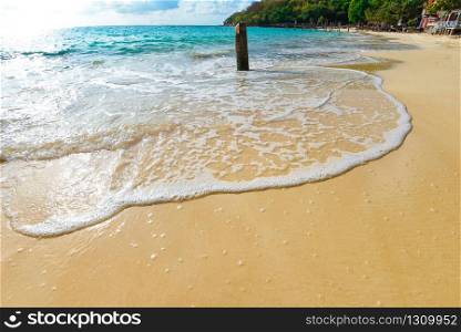 Sea waves on sand beach water and coast seascape / View of beautiful tropical landscape beach sea island with ocean blue sky and resort background in Thailand summer beach vacation