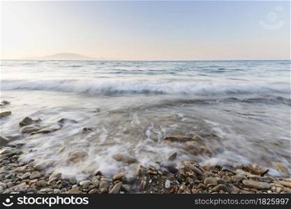 sea waves on the stone beach at sunset, Zakynthos, Greece