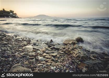 sea waves on the stone beach at sunset, Zakynthos, Greece