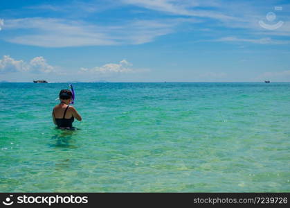 sea with asian young girl scuba diving at Krabi, Thailand focus on her