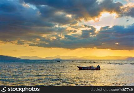 Sea with boat at sundown - Sunset saescape, landscape