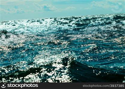 Sea with deep blue water waves splash glowing background