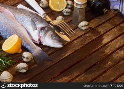 Seabass. Two Seabass raw fish on wooden table with copy space