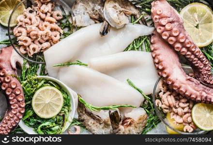 Seafood background with raw seafood and lemon slices, top view. Seafood shopping assortment. Healthy food