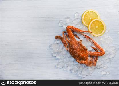Seafood crab boiled cooked lemon and ice on white wooden background / Blue Swimming Crab