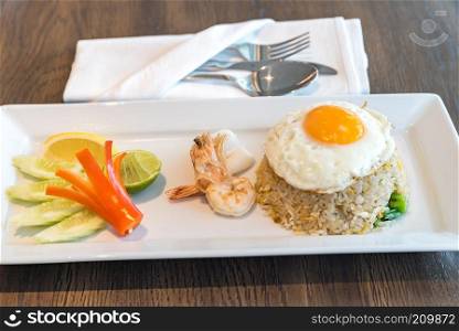 Seafood fried rice with squid and shrimp top with fried egg