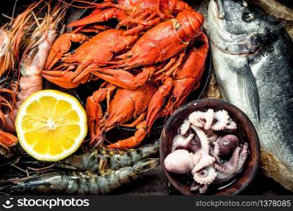 Seafood in an old tray. On a wooden background.. Seafood in an old tray.