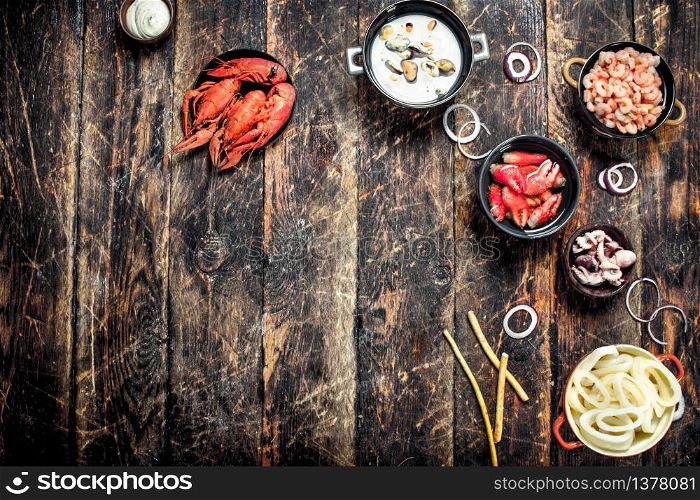 Seafood in bowls. On a wooden background.. Seafood in bowls.