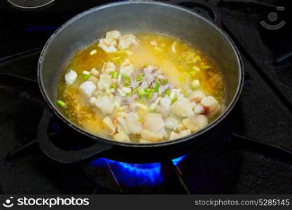 Seafood paella cooking process with cuttlefish squid