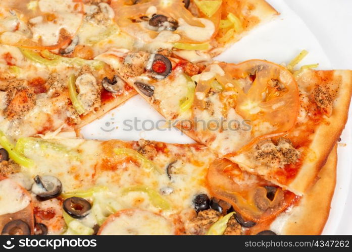 seafood pizza closeup with salmon, shrimps, tomato, pepper, olive and mozzarella cheese on a white background