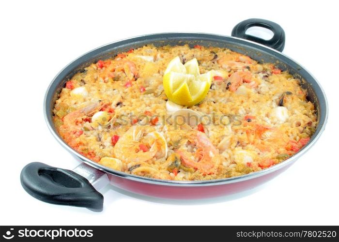 seafood rice with shrimp and lemon shrimp clams squid in paellera on white background