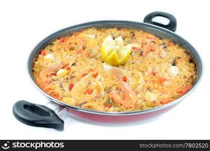 seafood rice with shrimp and lemon shrimp clams squid in paellera on white background