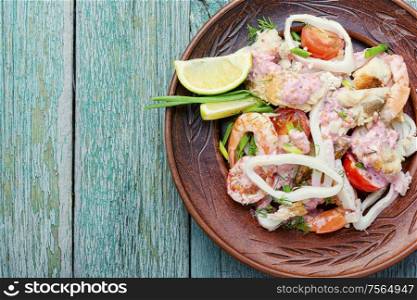 Seafood salad with prawns, mussels and squids. Delicious spicy seafood salad