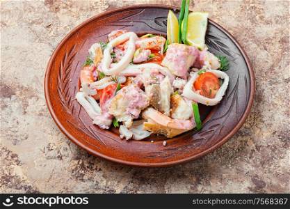 Seafood salad with prawns, mussels and squids. Delicious spicy seafood salad