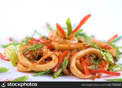 Seafood salad with squid and vegetables closeup