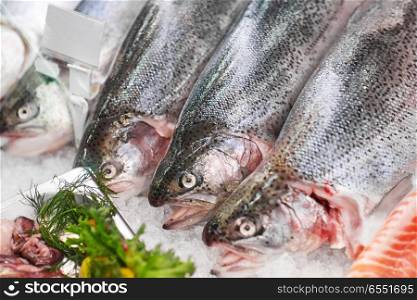 seafood, sale and food concept - chilled fresh fish on ice at grocery stall. fresh fish on ice at grocery stall. fresh fish on ice at grocery stall