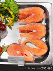 seafood, sale and food concept - chilled fresh salmon fish fillet in metal tray on ice at grocery store. salmon fish fillet in metal tray on ice at grocery. salmon fish fillet in metal tray on ice at grocery