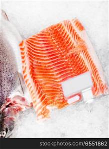 seafood, sale and food concept - chilled fresh salmon fish fillet on ice at grocery store. salmon fish fillet on ice at grocery. salmon fish fillet on ice at grocery