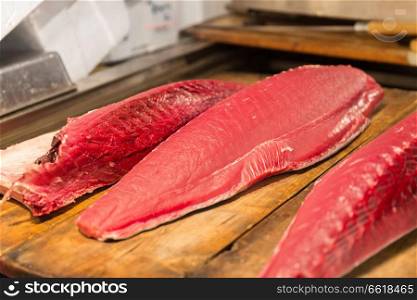 seafood, sale and food concept - fresh tuna fish at japanese street market. fresh tuna fish at japanese street market