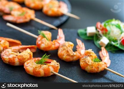 Seafood set with Lobsters, Clams, Fish, Blue Clabs, Big Prawns, Mussels and Calamari Squids with pieces of lemon   vetgetables. Catering shrimp brochettes.