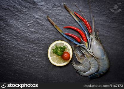 Seafood Shrimps Shellfish / Fresh prawns ocean gourmet raw shrimp with chilli tomato lemon and green parsley on dark background