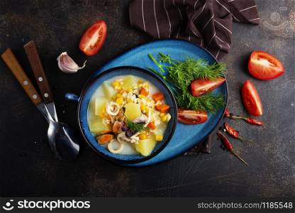 seafood soup in blue bowl on a table