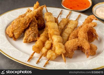 Seafood tempura with fish and shrimp on black stone table