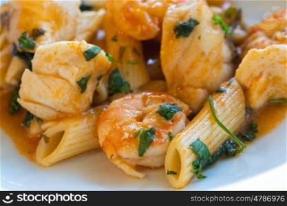 Seafood with macaroni, shrimps, fish and penne