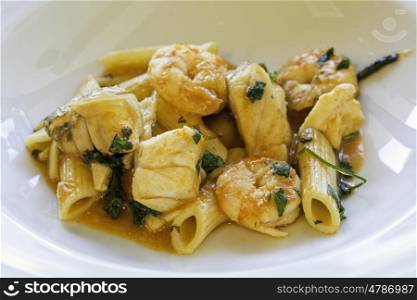 Seafood with macaroni, shrimps, fish and penne