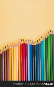 seamless colorful pencils arranged row yellow surface