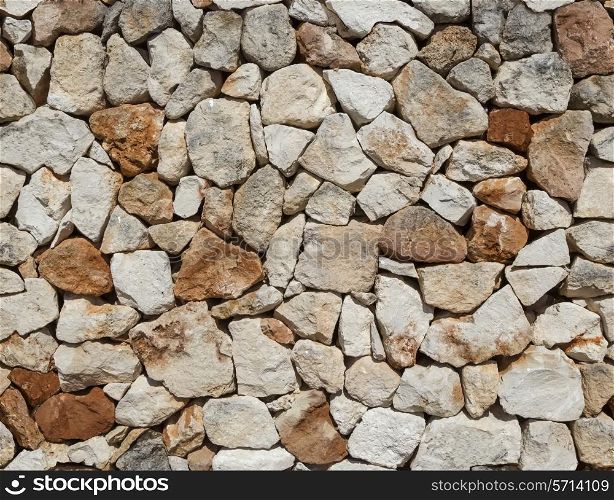 Seamless rough medieval stone wall background.